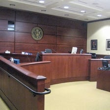 A courtroom with a judge’s bench and seating for a trial