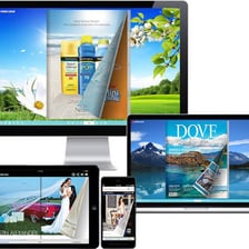 A laptop displaying an online magazine homepage