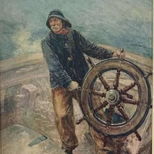 A ship’s captain standing at the wheel and steering.