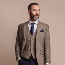A decorative pocket square folded in the breast pocket of a suit jacket