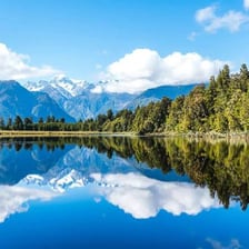 A lake surrounded by land and natural scenery