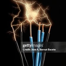Sparks arcing between exposed electrical wires.