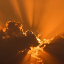 Bright golden light shining through gaps in clouds