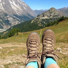 A sturdy hiking boot worn on a mountain trail
