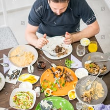 A person eating a meal at a table.