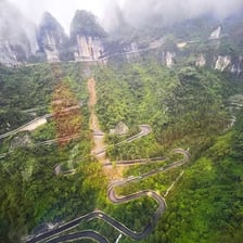 A curving mountain road with repeated bends along a steep slope