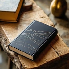 A closed book viewed from above with its cover clearly visible