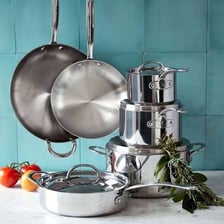 A display of cookware including pots and pans in a kitchen retail setting