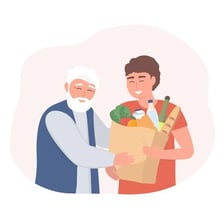 A volunteer helps another person carry groceries.