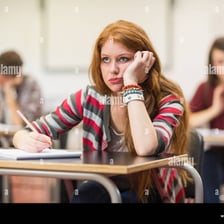 A bored person staring blankly during a classroom lesson