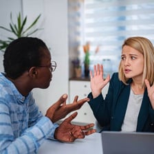 One person stopping another and holding them in an extended conversation.