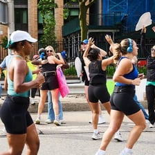 A runner follows behind the main group in a race.
