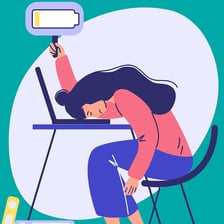 A tired person resting at a desk after prolonged work.