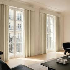 Fabric curtains hanging over a household window.