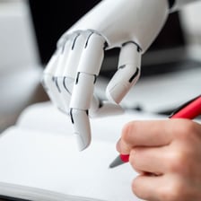 A person removing written information from a document.