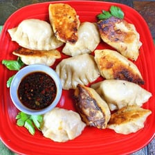 A plate of browned Chinese potstickers