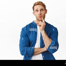 A person sitting thoughtfully with a hand near the chin