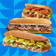 A club sandwich shown beside a submarine sub sandwich
