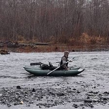 A small boat floating freely on a river current