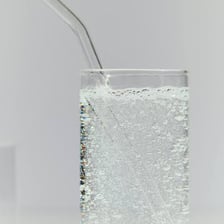 Glass of clear carbonated seltzer water with visible bubbles