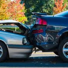Two cars involved in a minor fender-bender collision.