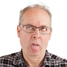 A person reacting to the bitter taste of food