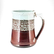 A large ceramic beer stein used as a mug