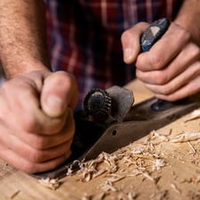 A person using skilled hands to work carefully with a tool