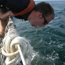 A person appearing queasy while traveling on a boat
