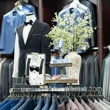 Men's ties and other formal clothing displayed in a shop.