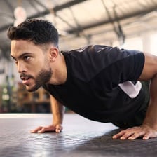 A person performing a push-up with the body held straight