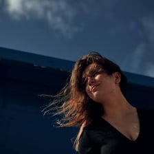 Wind blowing through and tangling a person's hair.