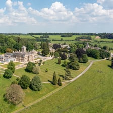 A manor house surrounded by landscaped grounds