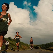 An energetic teenager running outdoors