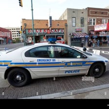 A police squad car traveling on a city street