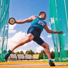 An athlete preparing to throw a discus in a track-and-field competition.