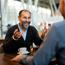 A person using a friendly manner to ease tension during a conversation