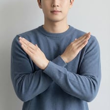 A person using a clear gesture to refuse a request.
