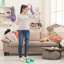A person arranging items to make a room neat and orderly.