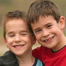 Two brothers standing together and smiling