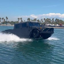 An amphibious vehicle transitioning between water and land