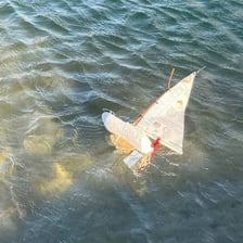 A sailboat making a sharp turn on the water.