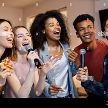 A group of friends singing karaoke together with microphones.