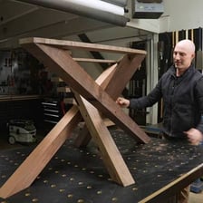 A table and a spider, each visibly supported or moving on legs.