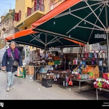 A vendor selling goods at a market stall