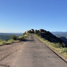 A road extending toward a different destination in the landscape