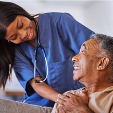 A registered nurse caring for a patient in a clinical setting.