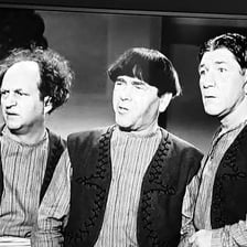 The Three Stooges performing a slapstick comedy routine.