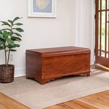 A wooden cedar chest used for storing clothing or linens