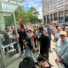 A person standing firmly while facing opposition in a public protest.